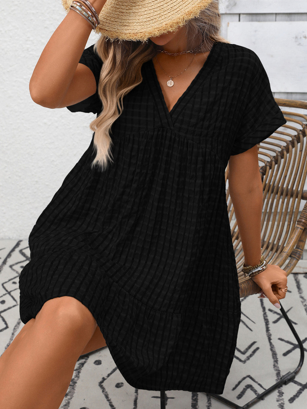 Lightweight plaid V-neck mini dress with ruffle hem from Trendsi, perfect for seasonal fashion, shown on a model.
