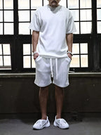 Plus size men's short sleeve top and shorts set by Trendsi, featuring a casual, comfortable fit with a coordinated matching design.