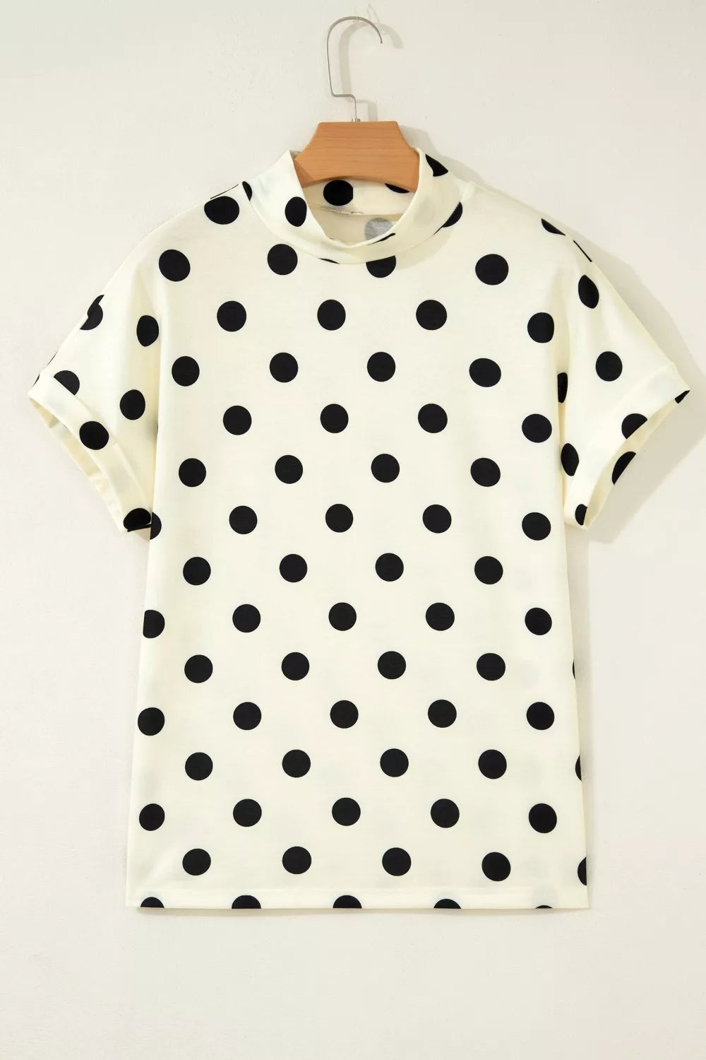Polka dot print high neck dolman top from Trendsi, featuring a relaxed fit and stylish design with bold black and white dots.
