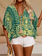 Women's printed V-neck half sleeve casual top by Trendsi, featuring soft stretch fabric and stylish office blouse design.