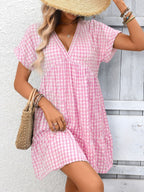 Lightweight plaid V-neck mini dress with ruffle hem from Trendsi, perfect for seasonal fashion and casual wear.