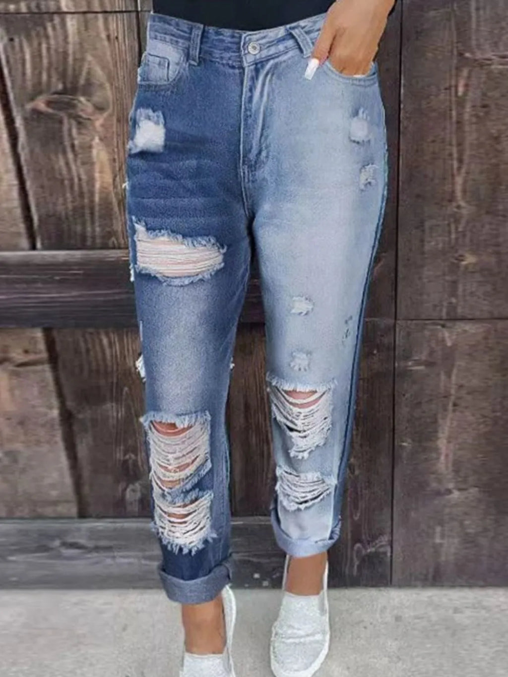 Distressed jeans with pockets by Trendsi, showcasing a casual fit, ripped details, and front and back pockets.