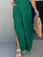 Plus size maxi dress with slit V-neck, smocked waist, and flowing fabric from Trendsi, shown in full length.
