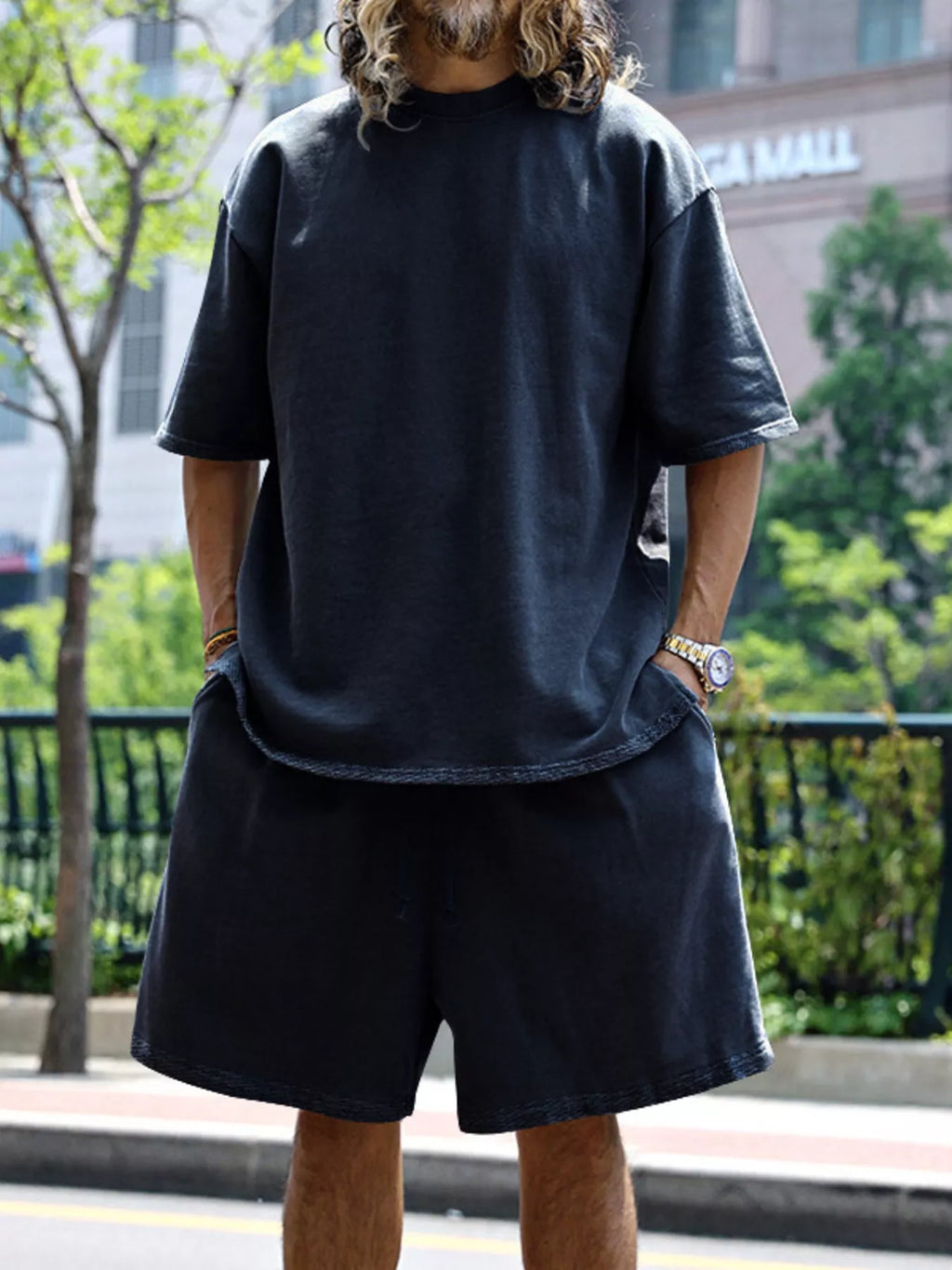Plus size men's relaxed fit T-shirt and shorts set by Trendsi, featuring comfortable casual fit and soft fabric.