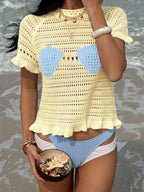 Openwork ruffled hem knit top by Trendsi, featuring a stylish openwork pattern and feminine ruffled hem detail.