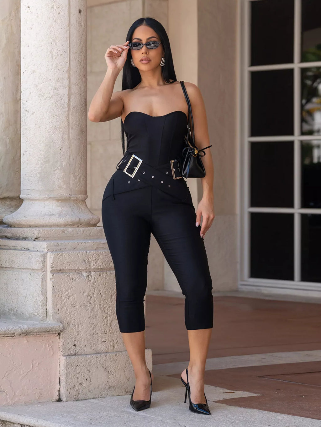 Black belted tube skinny jumpsuit by Trendsi featuring a fitted silhouette and sleeveless design, perfect for chic, casual wear.