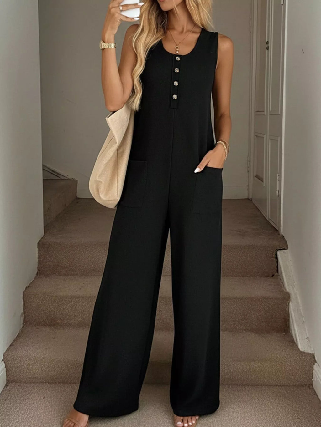 Sleeveless button-front wide-leg jumpsuit from Trendsi, featuring a comfortable and stylish romper design with a relaxed fit.