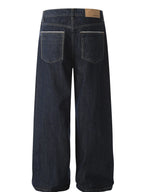 Men's wide leg denim jeans by Plush Fashion Shop, showing the relaxed fit and classic blue wash with visible stitching.