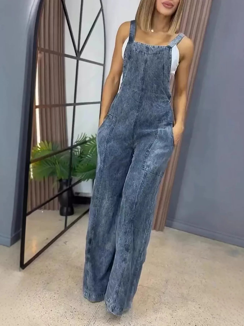 Full size wide-leg denim overalls by Trendsi, one-piece with adjustable straps and front pockets, shown on a model.