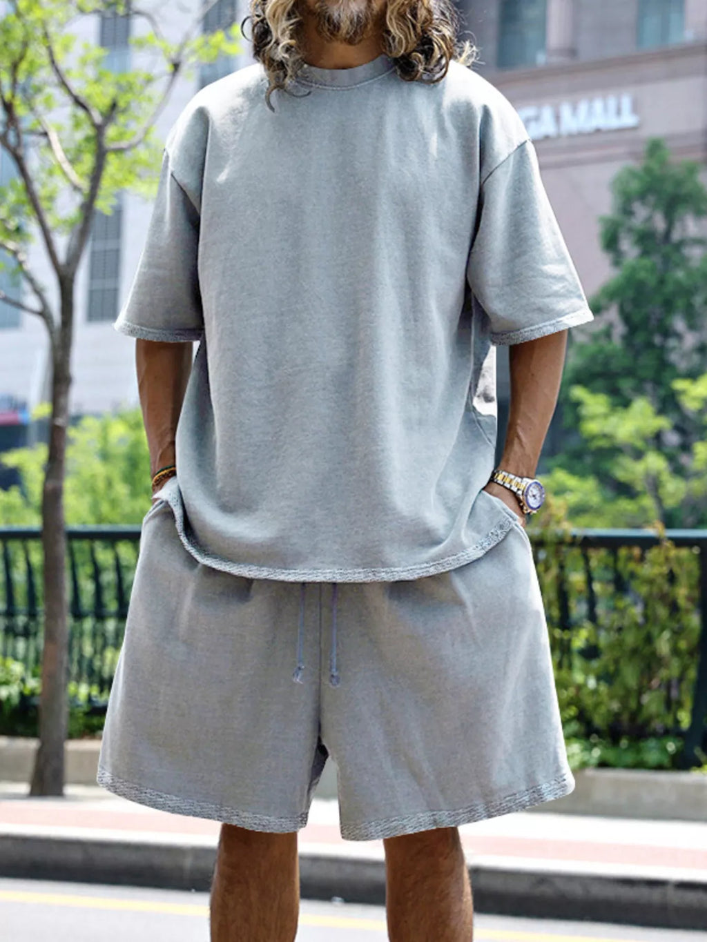 Plus size men's relaxed fit T-shirt and shorts set by Trendsi, featuring comfortable casual wear in a full size.