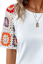 Geometric print round neck short sleeve blouse by Trendsi, featuring a stylish pattern and comfortable fit.