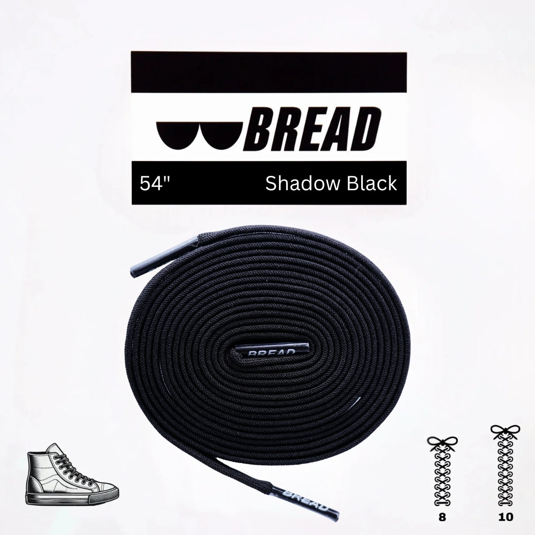 Black elastic shoelace by Bread, classic shadow black color, shown threaded through shoe eyelets for a snug fit.