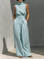 Sleeveless turtleneck top and wide-leg pants set from Trendsi, featuring a stylish, coordinated outfit in neutral tones.