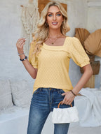 Asymmetrical neck short sleeve T-shirt with eyelet details, casual trendy top from Trendsi, shown in black with stylish design.