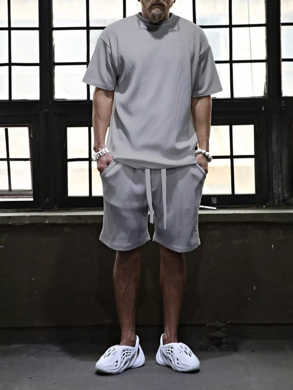 Plus size men's short sleeve top and shorts set by Trendsi, featuring a casual, comfortable summer outfit in a coordinated design.