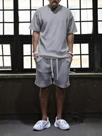 Plus size men's short sleeve top and shorts set by Trendsi, featuring a casual, comfortable summer outfit in a coordinated design.