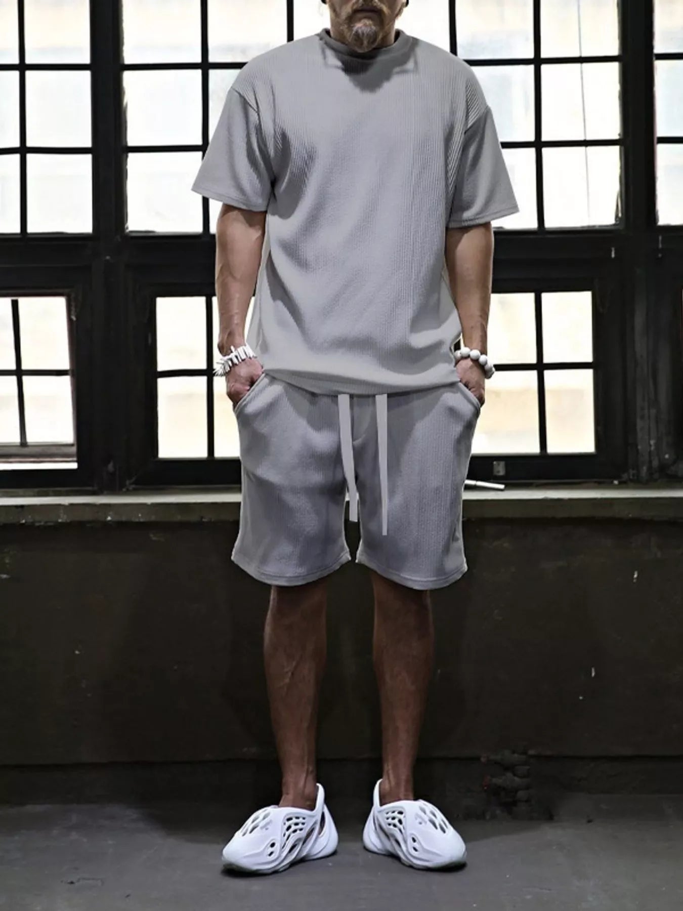 Plus size men's short sleeve top and shorts set by Trendsi, featuring a casual, comfortable summer outfit in a coordinated design.