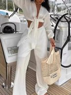 Textured tie-front crop top and wide-leg pants two-piece set by Trendsi, shown in a stylish matching outfit.
