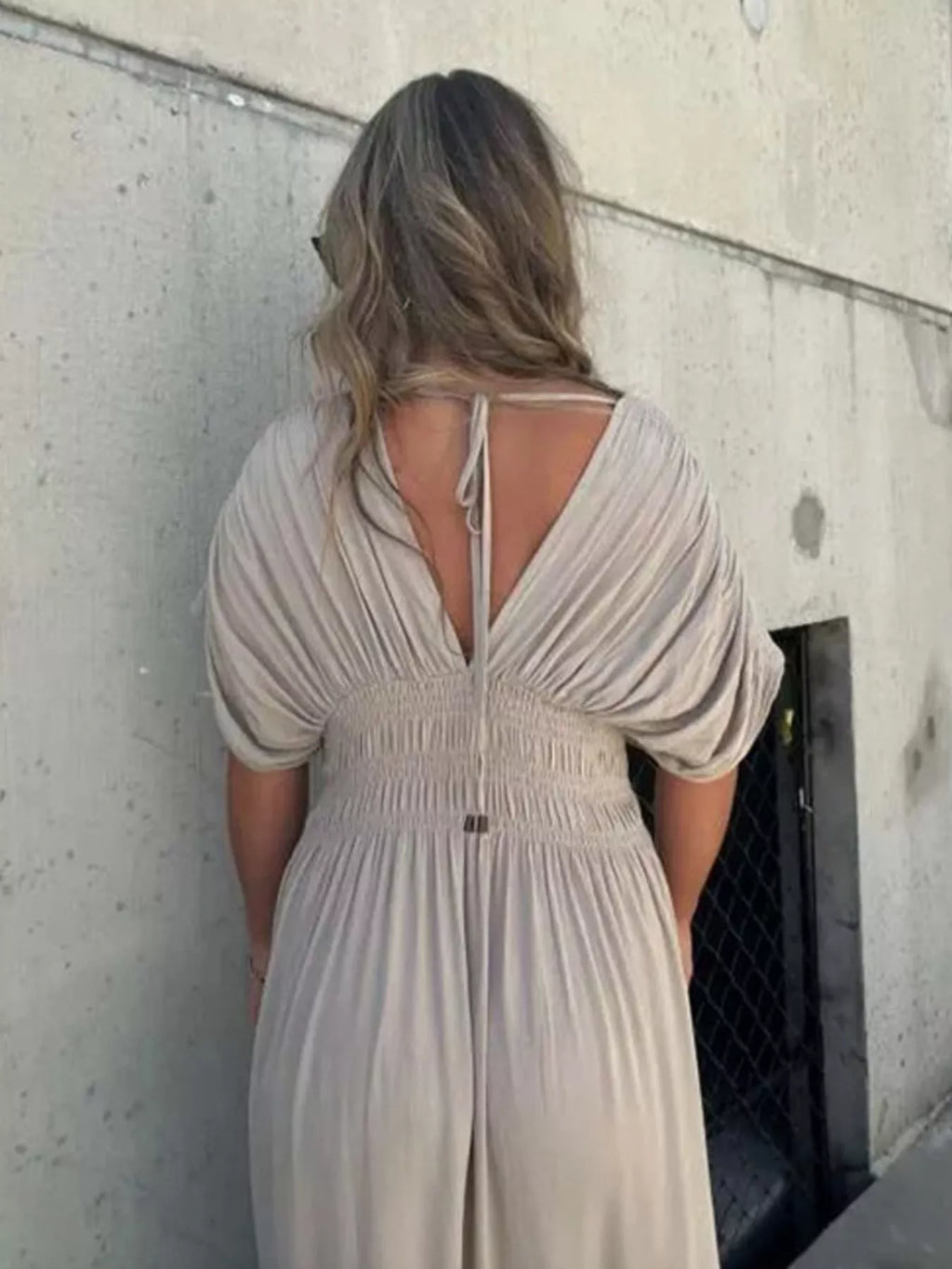 Plus size maxi dress with slit V-neck, smocked waist, and flowing fabric by Trendsi, perfect for casual or dressy occasions.
