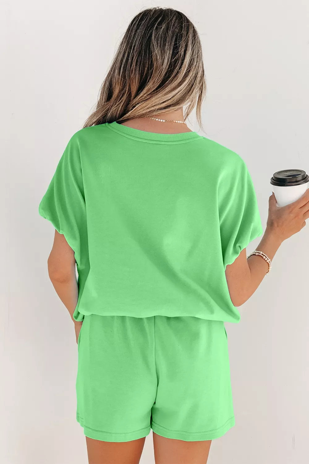 Solid color puffy loose top and drawstring shorts 2-piece outfit by Trendsi, featuring comfortable, casual summer wear.