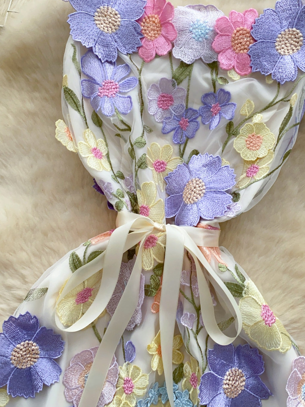 Floral embroidered tie waist mini dress by Trendsi featuring an elegant summer A-line silhouette with floral embroidery details.