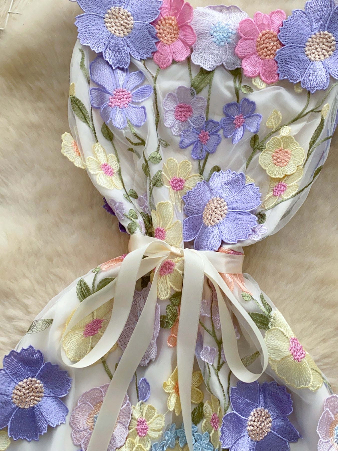 Floral embroidered tie waist mini dress by Trendsi featuring an elegant summer A-line silhouette with floral embroidery details.