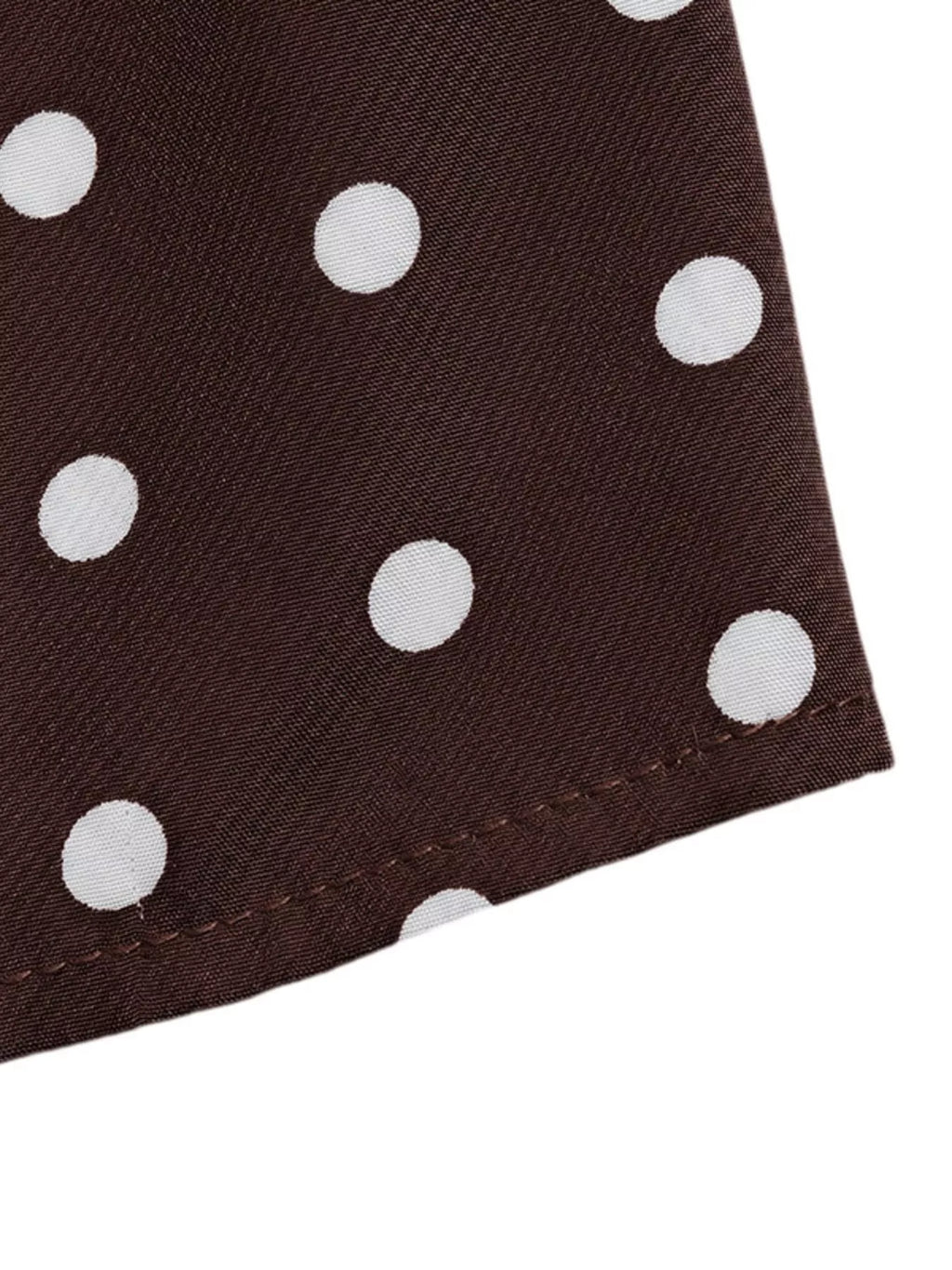 Polka dot halter neck mini dress by Trendsi, featuring a stylish halter neckline and playful polka dot pattern.