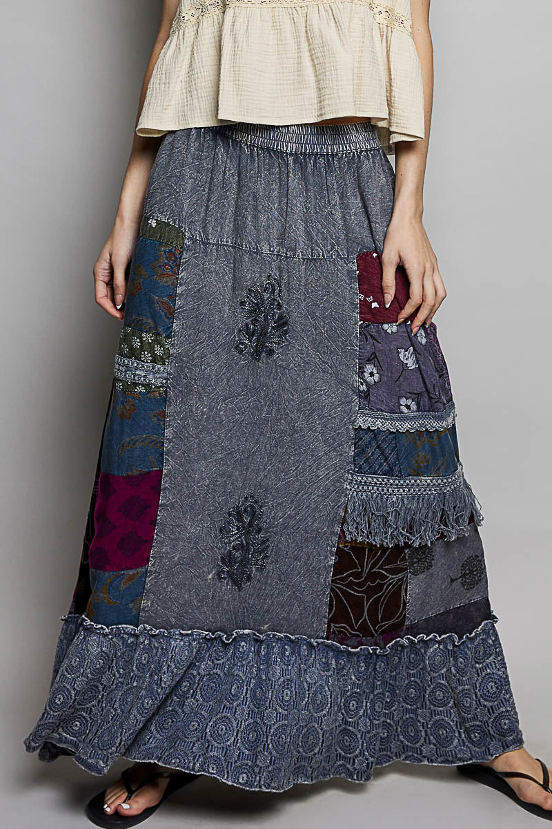 Bohemian printed patchwork embroidered ruffled maxi skirt with colorful patterns and flowing fabric, styled for a boho look.