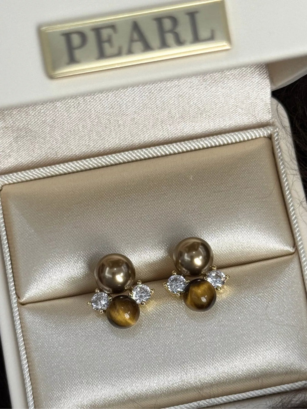 Tiger Eye stud earrings featuring polished, round gemstone jewelry with silver-tone settings, perfect for everyday wear.