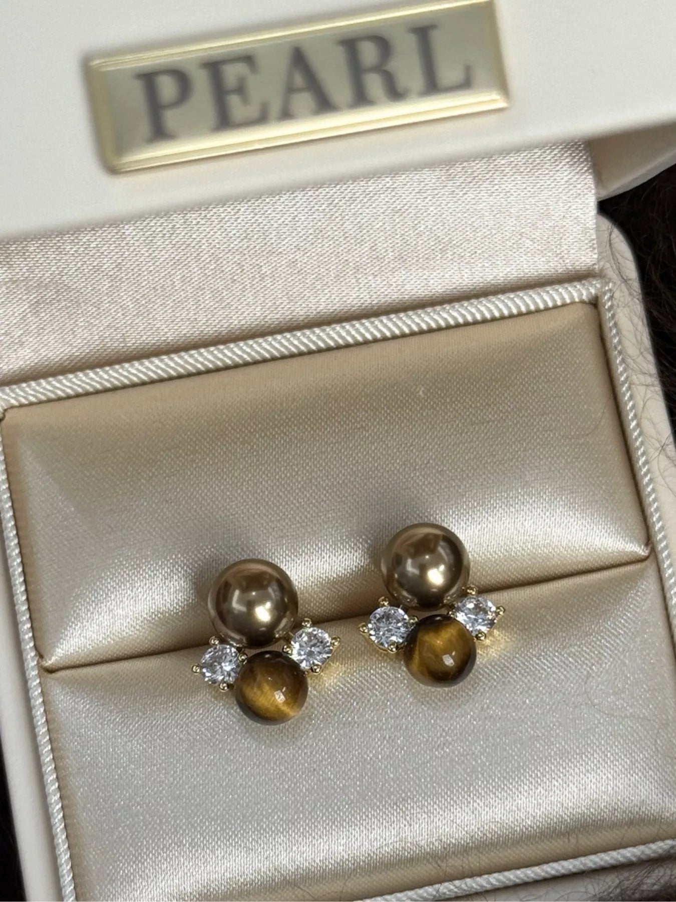 Tiger Eye stud earrings featuring polished, round gemstone jewelry with silver-tone settings, perfect for everyday wear.