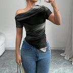 Black and white ombre off-the-shoulder mesh top with a ruched, asymmetrical hem, worn with blue jeans.