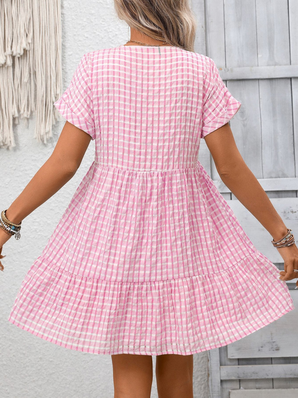 Lightweight plaid V-neck mini dress with ruffle hem from Trendsi, perfect for seasonal fashion, shown in a stylish, casual fit.