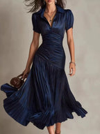 Pleated striped short sleeve midi dress by Trendsi, featuring a flowy design, vertical stripes, and a stylish, comfortable fit.