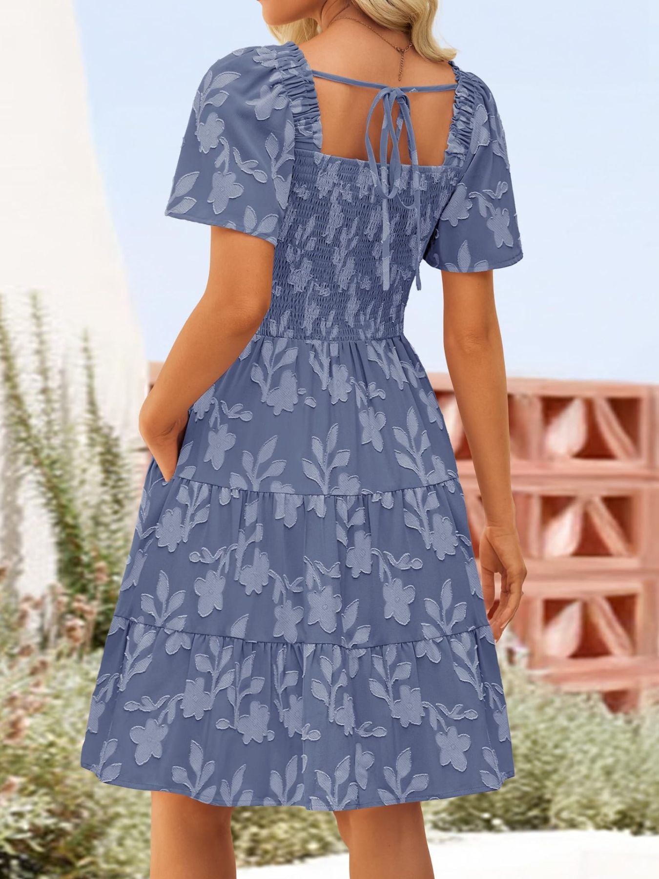 Women's smocked tiered square neck short sleeve casual dress with pockets by Trendsi, featuring a relaxed fit and stylish design.