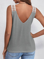 Women's V-neck waffle knit tank top with lace trim, featuring a soft texture and delicate detailing, perfect for casual wear.