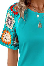 Geometric print round neck short sleeve blouse from Trendsi, featuring a colorful geometric pattern and comfortable fit.
