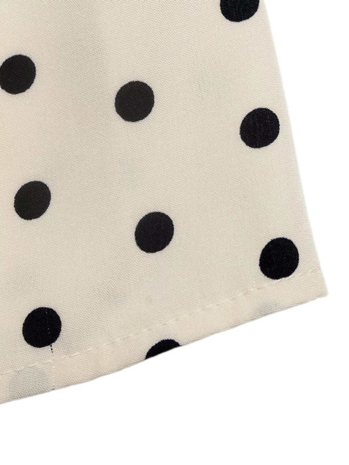 Polka dot halter neck mini dress by Trendsi featuring a fitted bodice and flared skirt, stylish and perfect for summer.