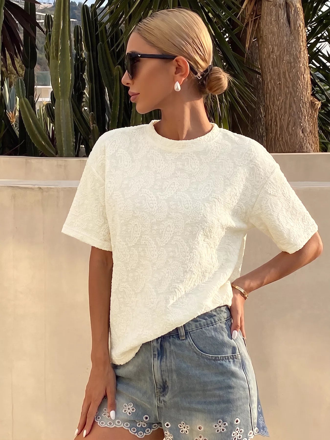 Textured paisley pattern casual T-shirt from Trendsi, showing a close-up of the intricate design and soft fabric texture.