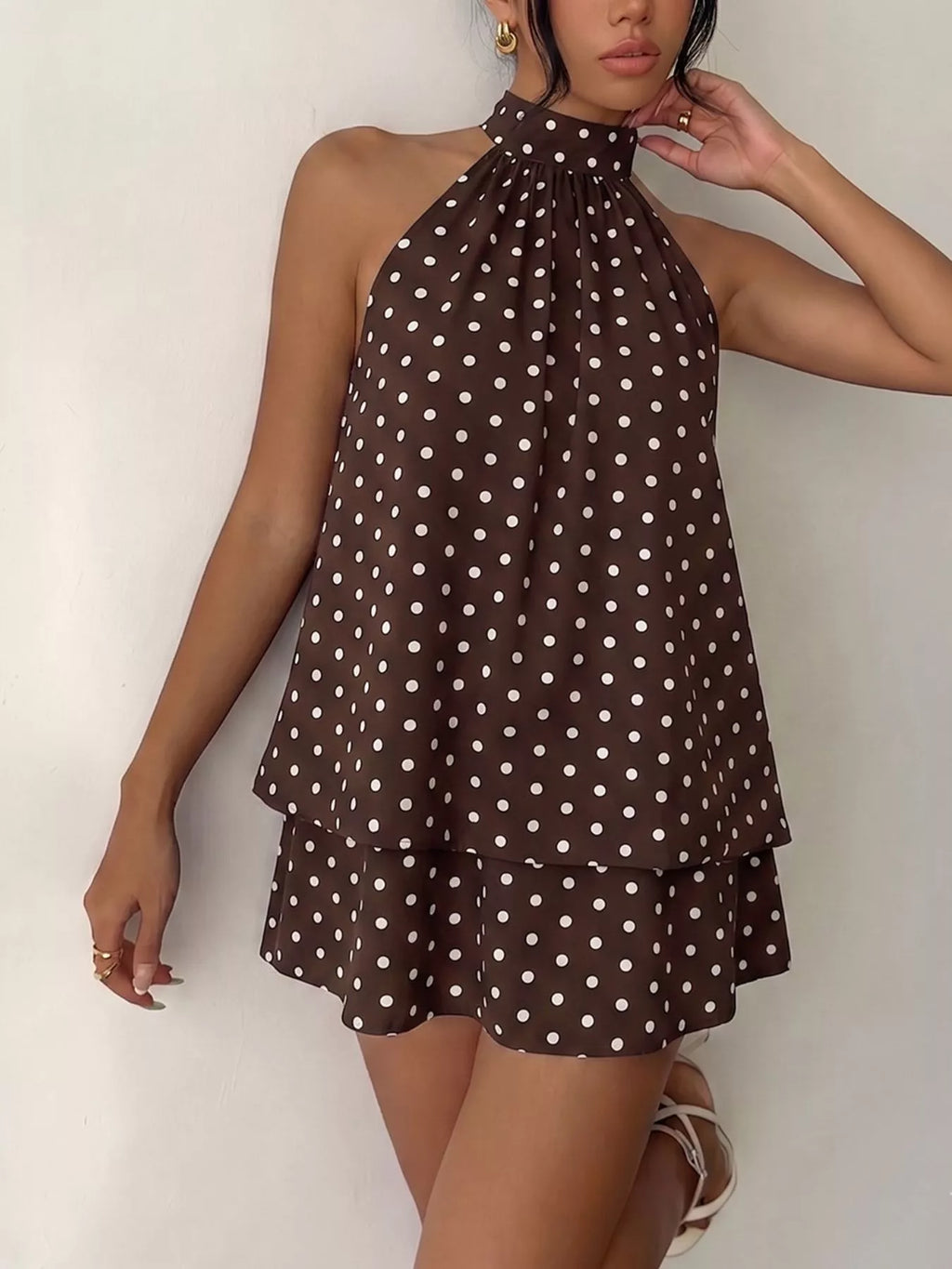 Polka dot halter neck mini dress by Trendsi, featuring a stylish design with a fitted silhouette and playful pattern.