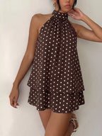 Polka dot halter neck mini dress by Trendsi, featuring a stylish design with a fitted silhouette and playful pattern.