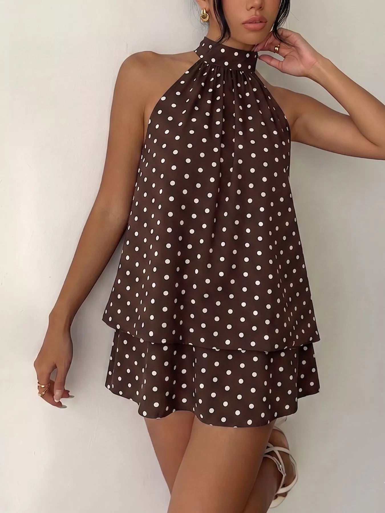 Polka dot halter neck mini dress by Trendsi, featuring a stylish design with a fitted silhouette and playful pattern.