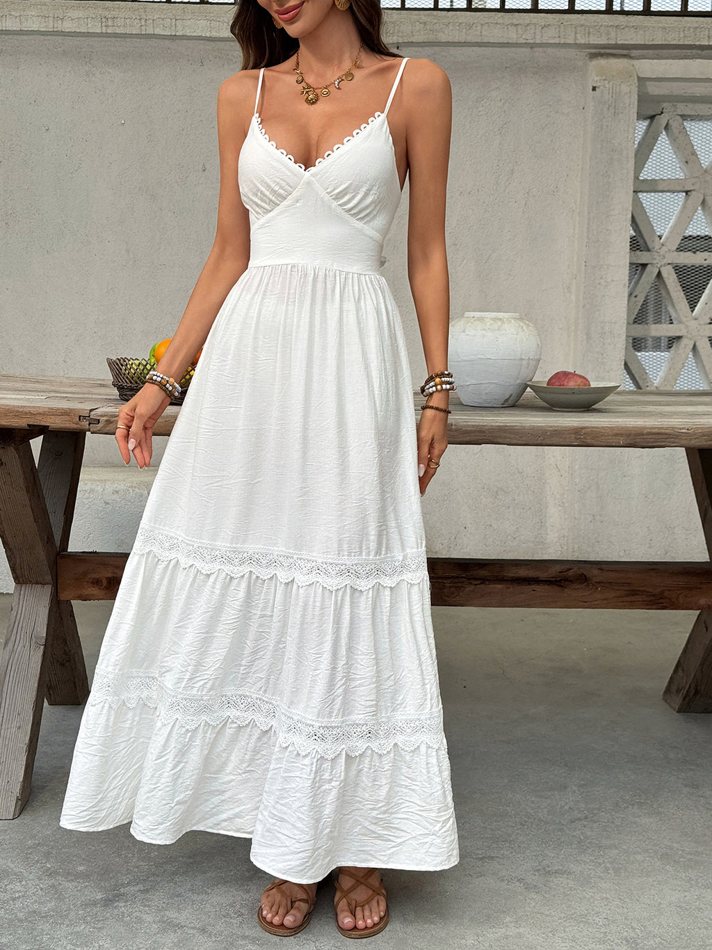 Women's V-neck tiered maxi dress with delicate lace details by Trendsi, flowing design, perfect for elegant summer occasions.