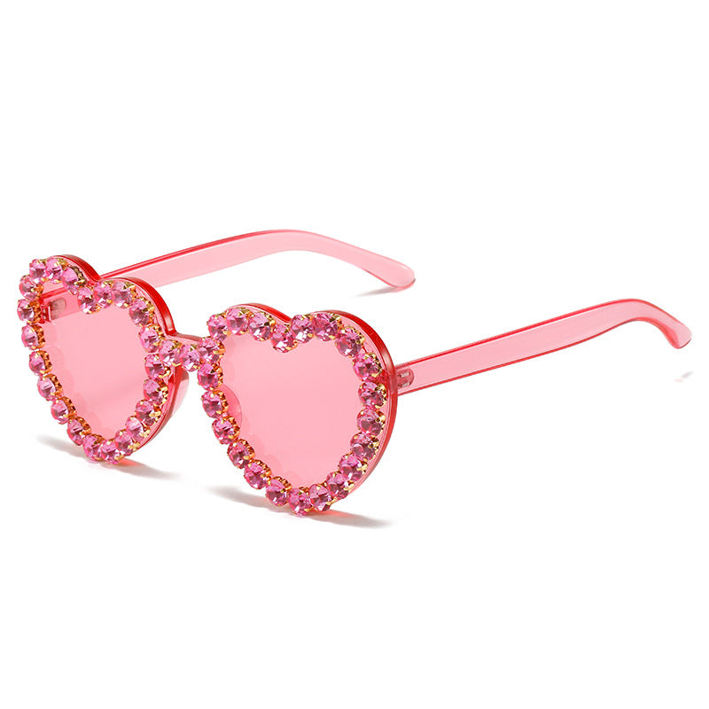 Peach heart-shaped rhinestone sunglasses by FitiqueFit with Y2K INS style, featuring bold frames and sparkling rhinestone accents.