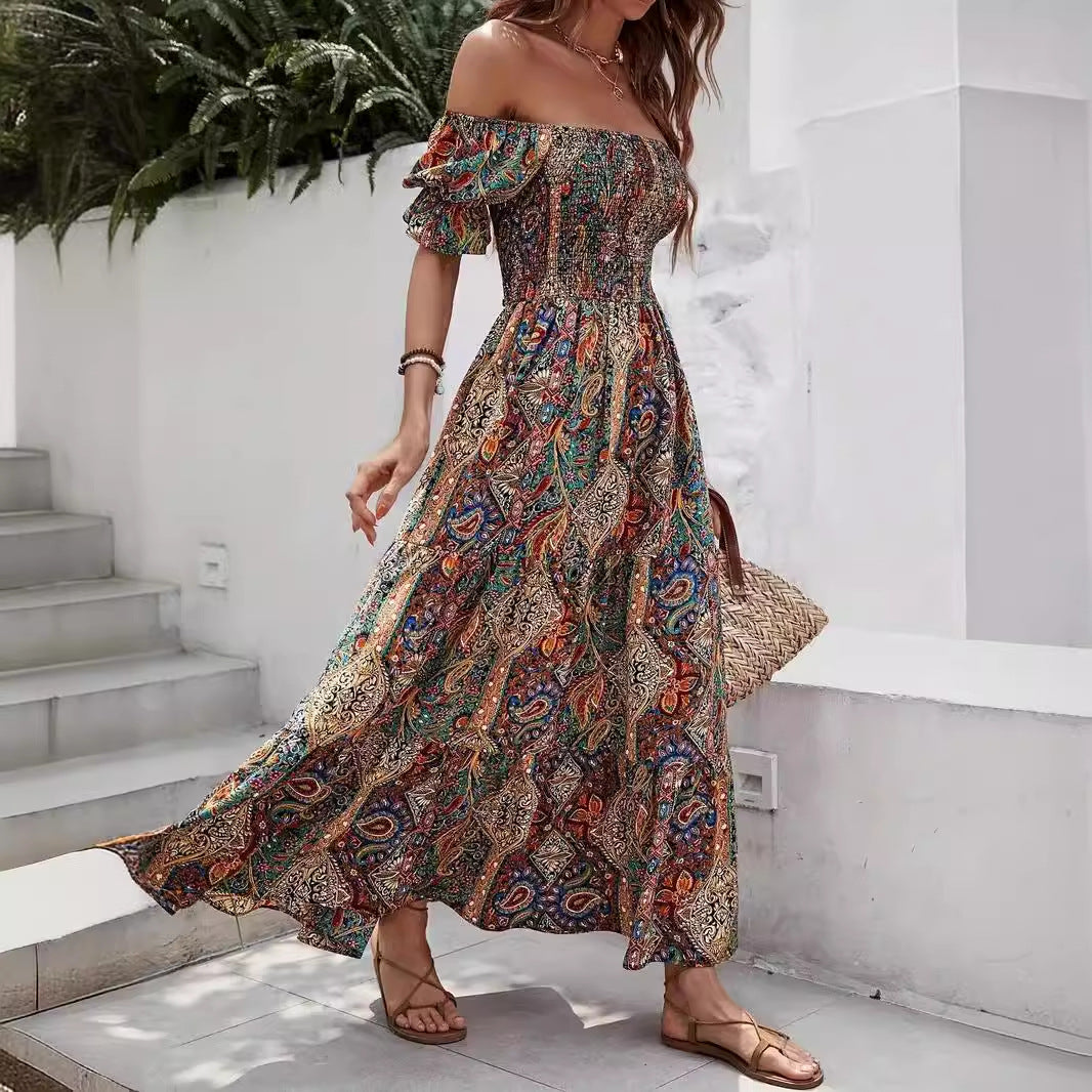 Boho-style off-the-shoulder maxi dress with a colorful, intricate paisley print and a smocked, fitted bodice.