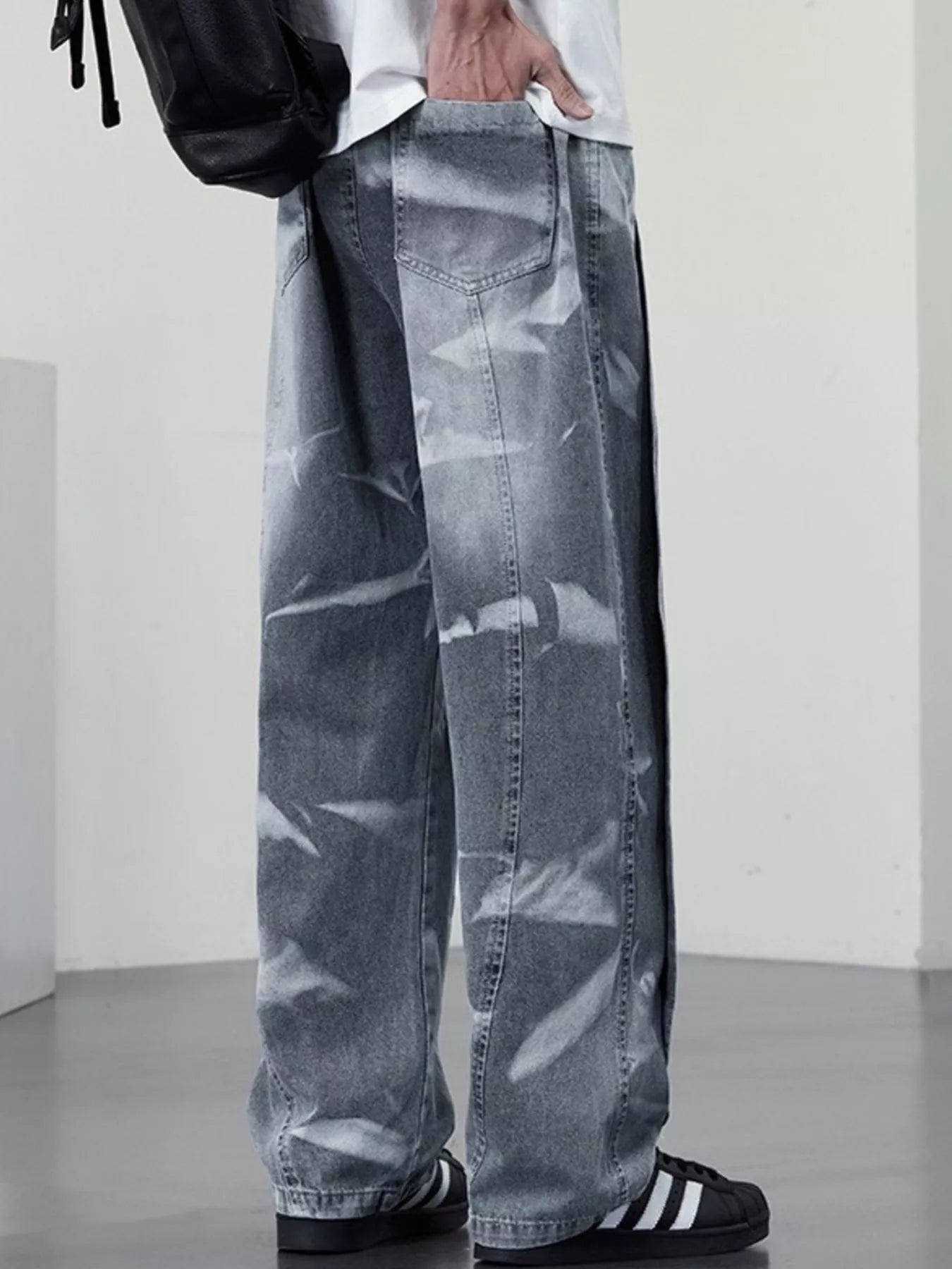Men's plus size washed wide-leg jeans from Trendsi, showing the relaxed fit and faded denim fabric.