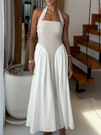Elegant two-tone halter neck ruched maxi dress with pockets, stylish women's dress from Trendsi featuring a flowing silhouette.