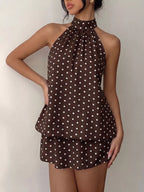 Polka dot halter neck mini dress by Trendsi, featuring a stylish design with a fitted bodice and flared skirt.