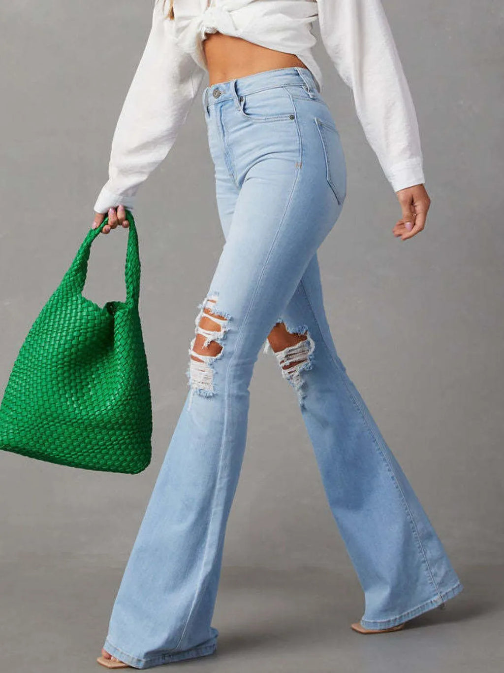 Distressed Trendsi jeans with front and back pockets, slim fit, featuring ripped details and a casual denim style.