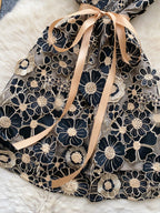 Floral embroidered tie waist mini dress by Trendsi featuring an elegant summer A-line silhouette with colorful floral embroidery.