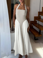 Elegant two-tone halter neck maxi dress with ruched details and pockets, stylish dress by Trendsi.